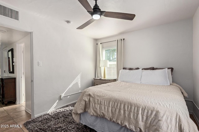 tiled bedroom with ceiling fan