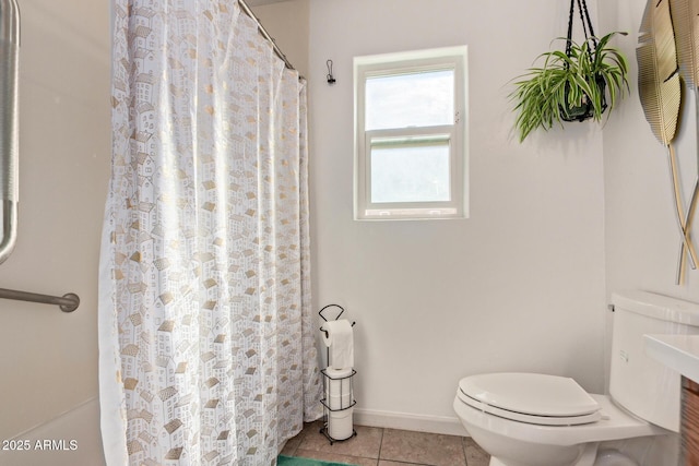 bathroom with tile patterned floors, toilet, and walk in shower