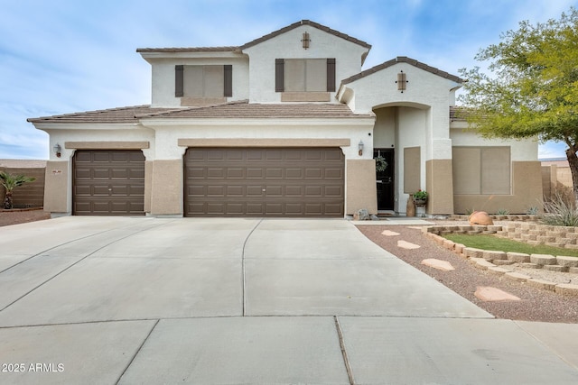 view of front facade with driveway, a tiled roof, and stucco siding