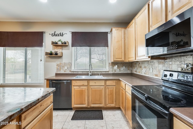 kitchen with stainless steel appliances, light brown cabinetry, a sink, and decorative backsplash