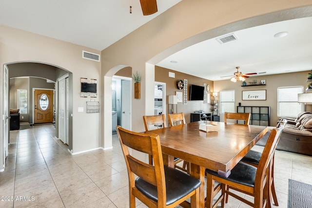 dining room featuring arched walkways, visible vents, and a ceiling fan