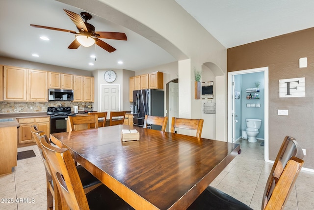 dining space with recessed lighting, baseboards, arched walkways, a ceiling fan, and light tile patterned flooring