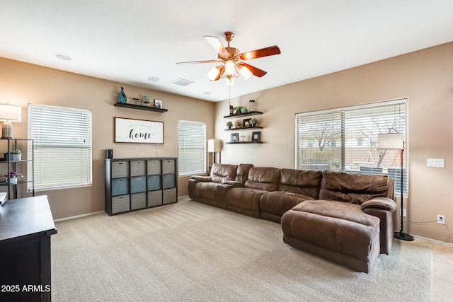 carpeted living area featuring ceiling fan, visible vents, and baseboards