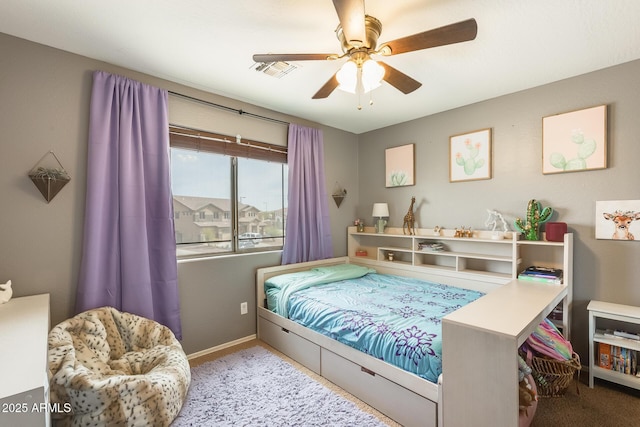 carpeted bedroom featuring baseboards, visible vents, and ceiling fan