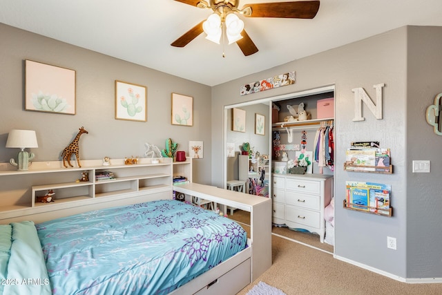 carpeted bedroom featuring a closet, a ceiling fan, and baseboards