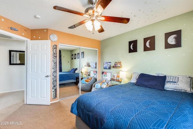 carpeted bedroom with baseboards, a closet, visible vents, and a ceiling fan