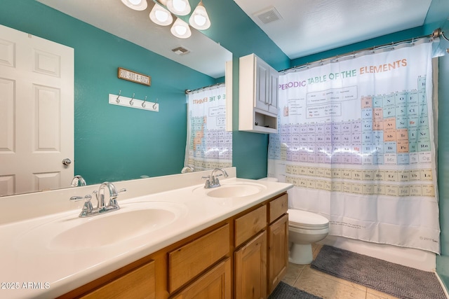 bathroom featuring toilet, a sink, and visible vents