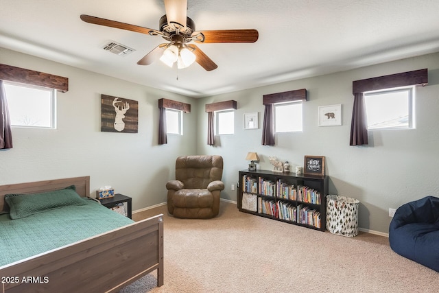 carpeted bedroom with a ceiling fan, visible vents, and baseboards