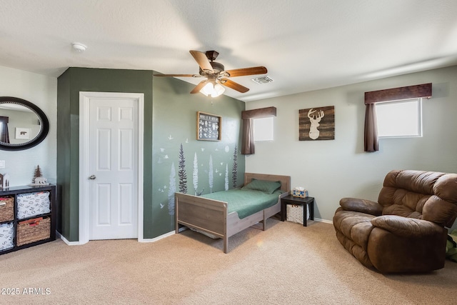 bedroom with a ceiling fan, carpet flooring, visible vents, and baseboards