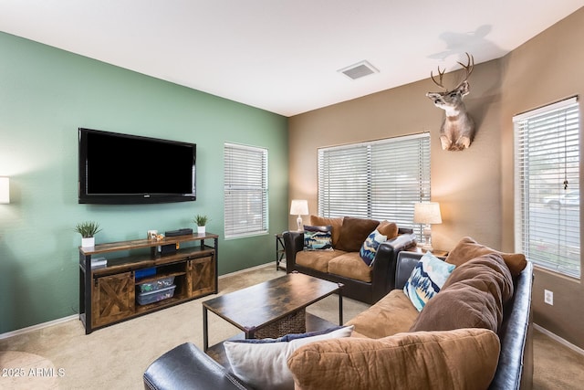 living area featuring baseboards, visible vents, and carpet flooring