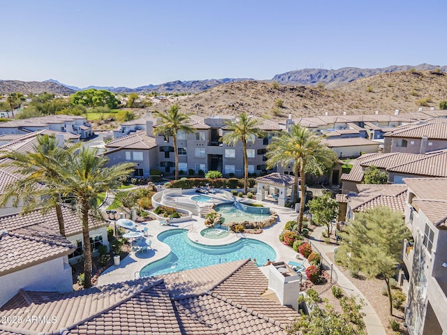 community pool featuring a gazebo, a residential view, a hot tub, a mountain view, and a patio area