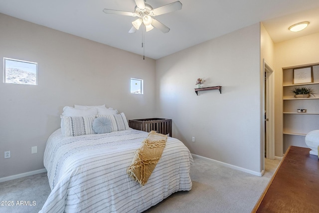 carpeted bedroom featuring baseboards and ceiling fan