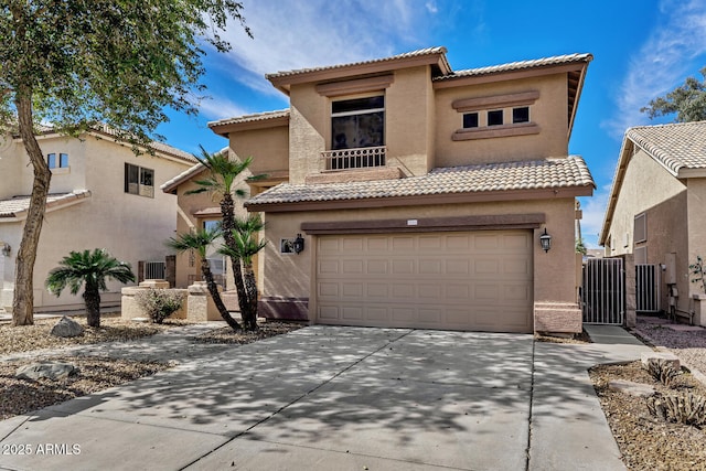 mediterranean / spanish-style home with a garage, a tiled roof, concrete driveway, and stucco siding