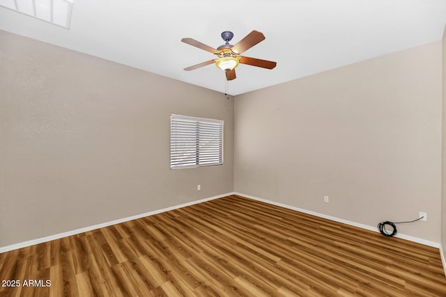 spare room featuring a ceiling fan, light wood-type flooring, visible vents, and baseboards