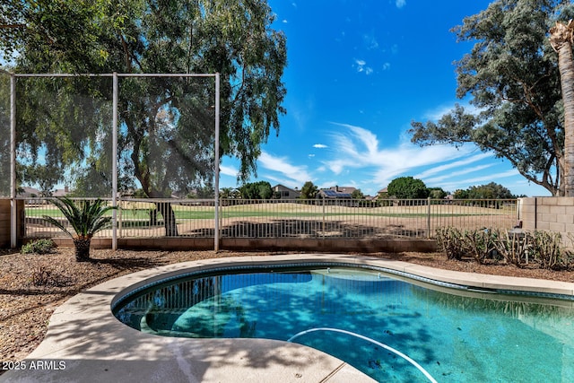 view of pool featuring fence