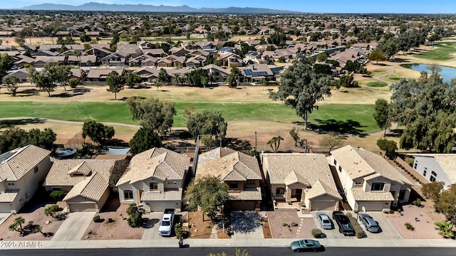 drone / aerial view featuring view of golf course and a residential view