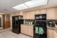 kitchen with black appliances, light tile patterned flooring, and light brown cabinets