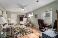 office area with a ceiling fan and wood finished floors