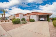 view of front of house with driveway and an attached carport