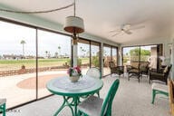 sunroom with plenty of natural light and a ceiling fan