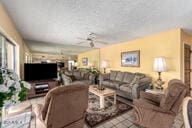 tiled living area featuring a ceiling fan