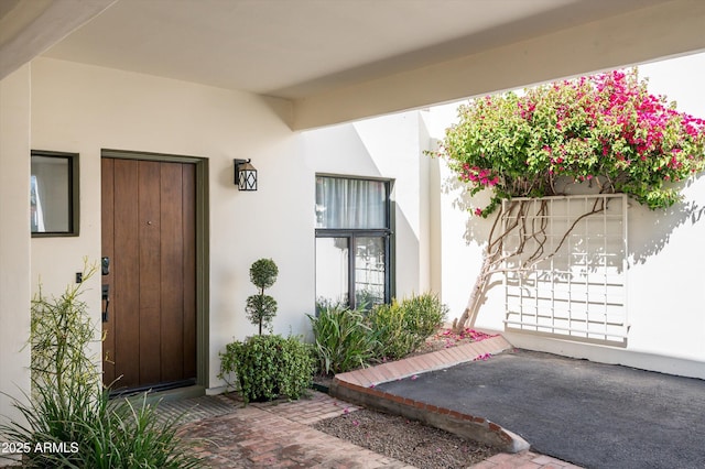 view of exterior entry with stucco siding