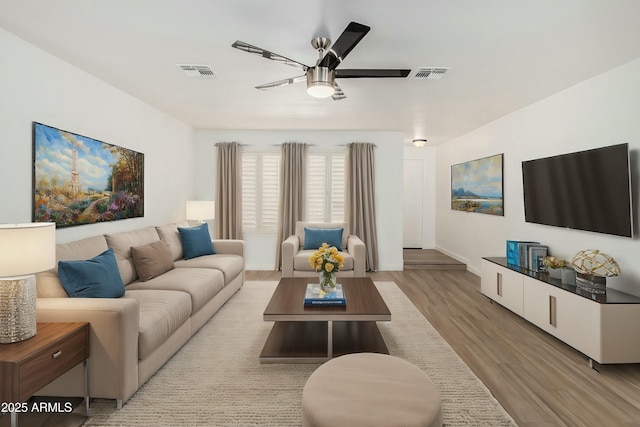 living room with visible vents, ceiling fan, and wood finished floors