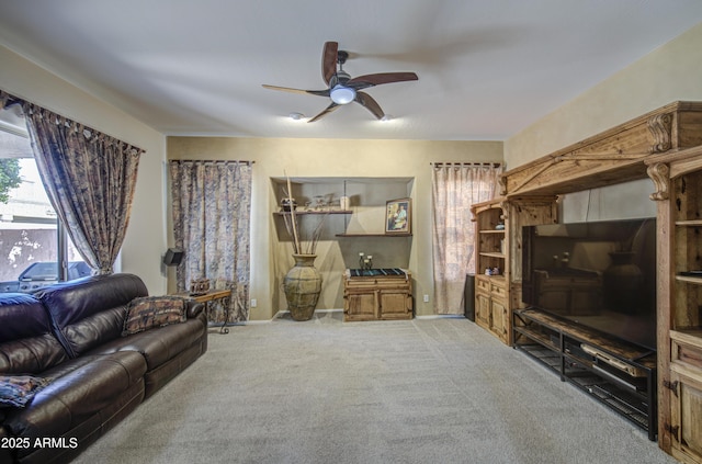 living room with baseboards, carpet, and ceiling fan