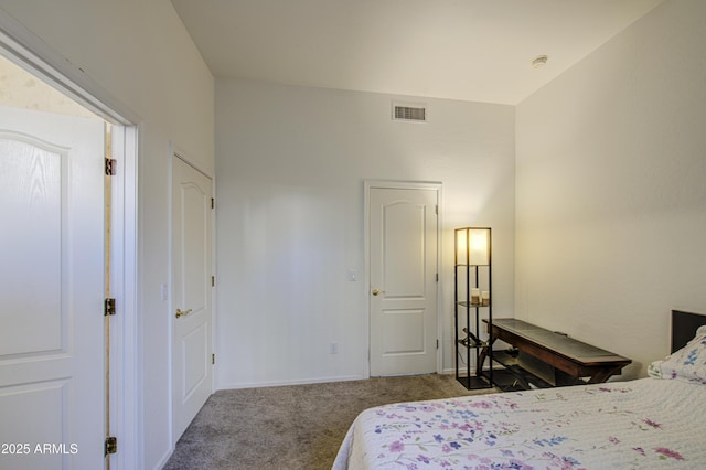 carpeted bedroom featuring baseboards and visible vents