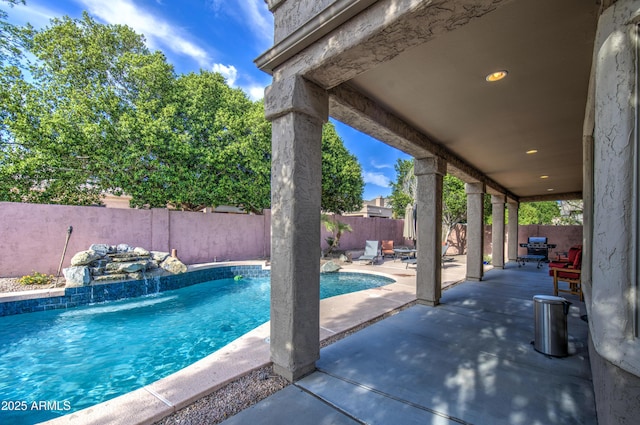 view of pool with a fenced backyard, a fenced in pool, and a patio