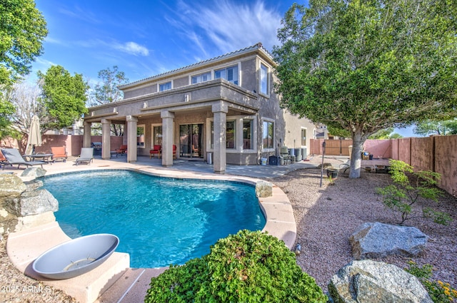 view of pool with a fenced in pool, a fenced backyard, a patio area, and central AC unit