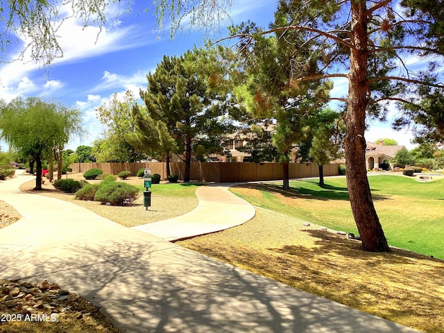 surrounding community featuring fence and a lawn
