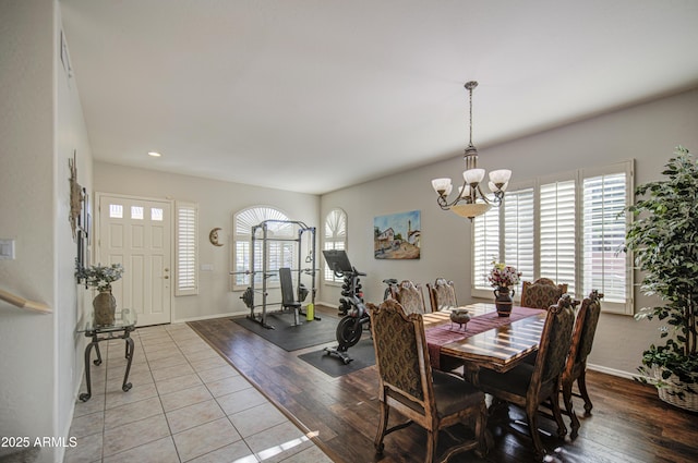 dining room featuring baseboards, recessed lighting, a chandelier, and hardwood / wood-style flooring