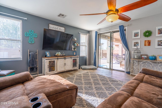 living room with hardwood / wood-style flooring, ceiling fan, and a healthy amount of sunlight