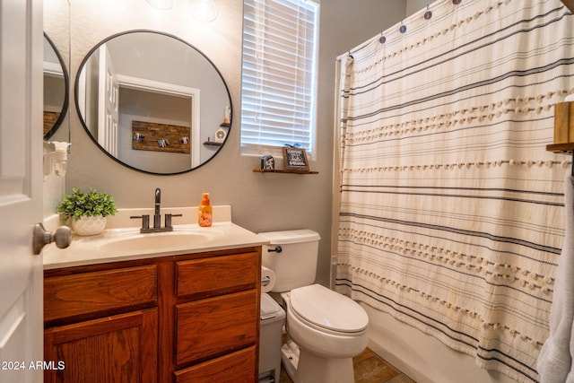 full bathroom featuring shower / tub combo, vanity, and toilet