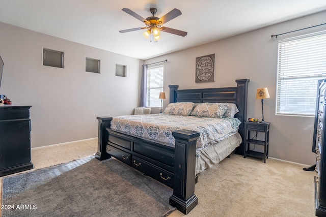 bedroom with carpet floors, multiple windows, and ceiling fan