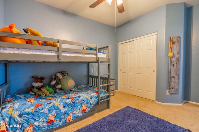 bedroom featuring ceiling fan, light colored carpet, and a closet