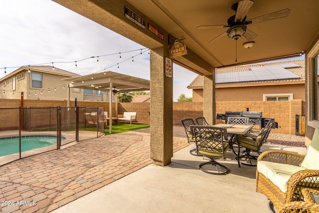 view of patio / terrace featuring outdoor lounge area, ceiling fan, and a fenced in pool