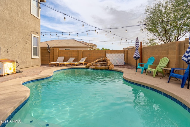 view of pool featuring pool water feature and a patio area