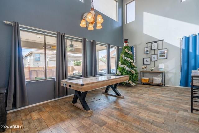 playroom with wood-type flooring and a notable chandelier