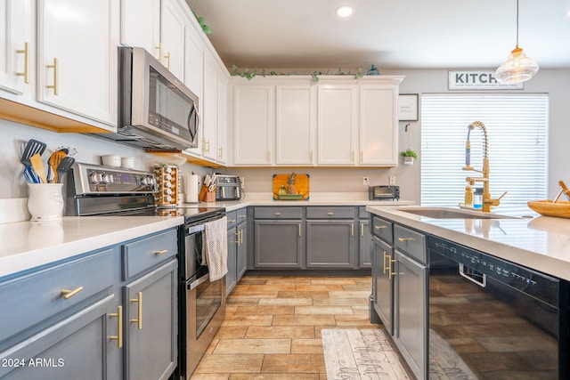 kitchen with gray cabinets, white cabinetry, sink, and stainless steel appliances