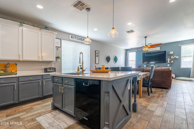 kitchen featuring gray cabinetry, sink, decorative light fixtures, dishwasher, and white cabinetry