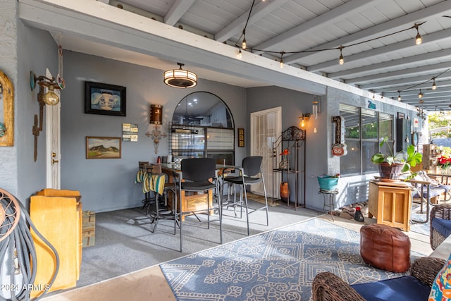 interior space featuring lofted ceiling with beams