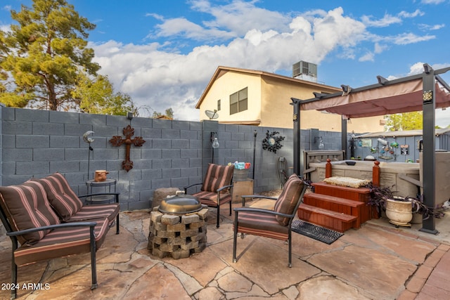 view of patio with an outdoor living space with a fire pit and central AC unit