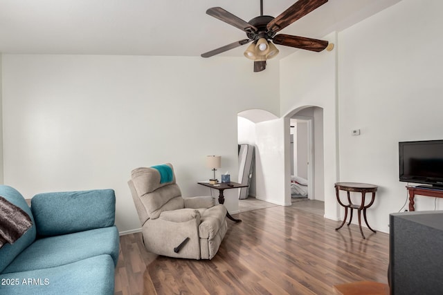 living room with wood-type flooring and ceiling fan