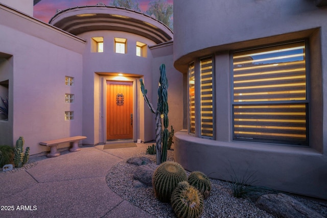 view of exterior entry at dusk