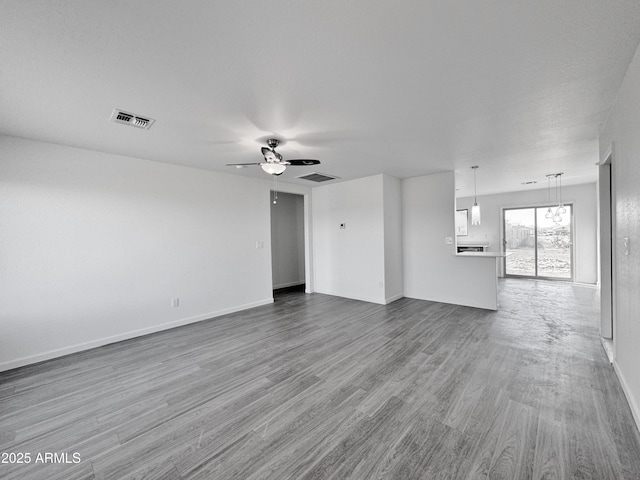 unfurnished living room with hardwood / wood-style flooring and ceiling fan