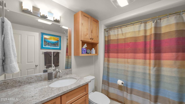 bathroom featuring toilet, a shower with shower curtain, and vanity