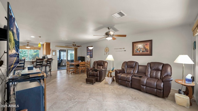 living room featuring light tile patterned floors and visible vents