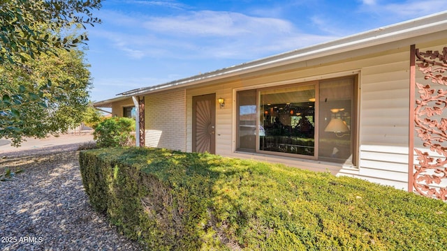 entrance to property with brick siding